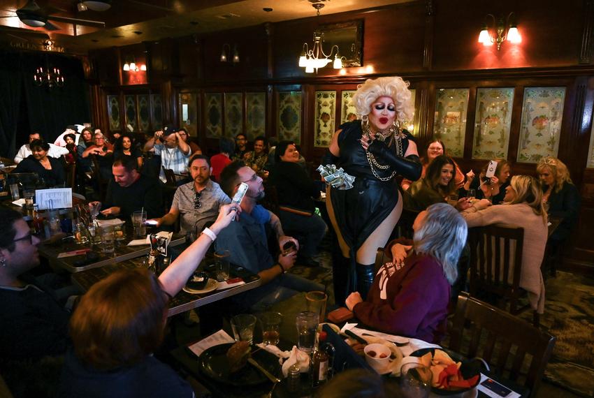 Daphne Rio, host of BuZz n' BabeZz drag brunch, collects tips at the end of Saturday’s show on Jan. 14, 2023.