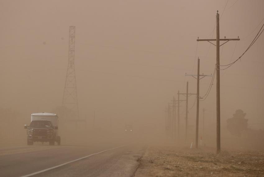 A motorist approaches the intersection of W. Farm Road 835 and S. Farm Road 835. High winds kicked up a dust storm that blanketed parts of West Texas on Tuesday afternoon, Feb. 14, 2023.