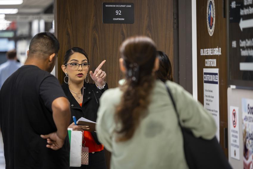 Viridiana Bernal Vega calls out names on the eviction docket at the Harris County Justice of the Peace on Tuesday, April 4, 2023, in Houston, TX. The court can have hundreds of eviction cases on its docket in a day.