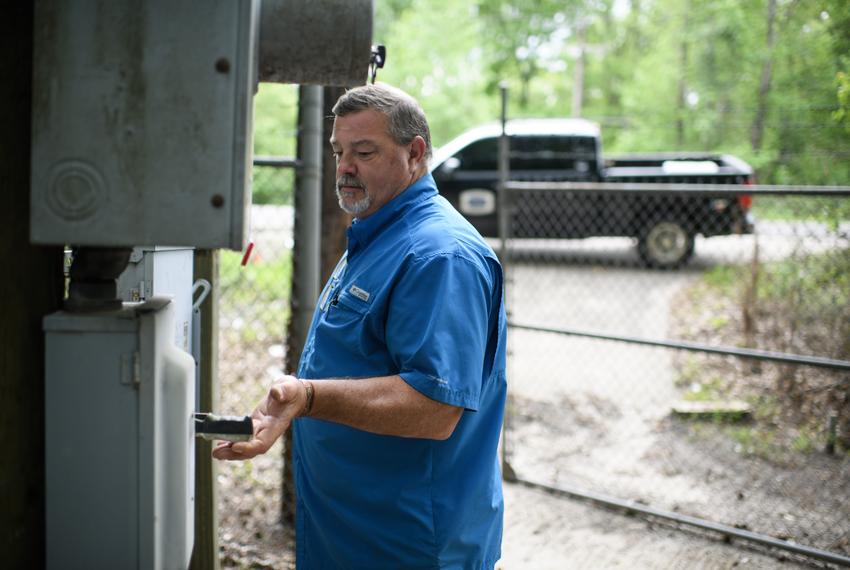 Tom Bailey turns the power back on after changing a fuse on April 10, 2023 in Zavalla.