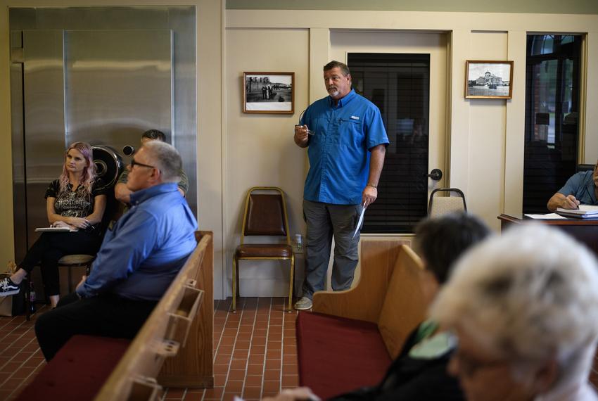 Tom Bailey talks during a city council meeting on April 10, 2023 in Zavalla, Texas. Seated against the wall is Joy Yarbrough, the city's water compliance coordinator.