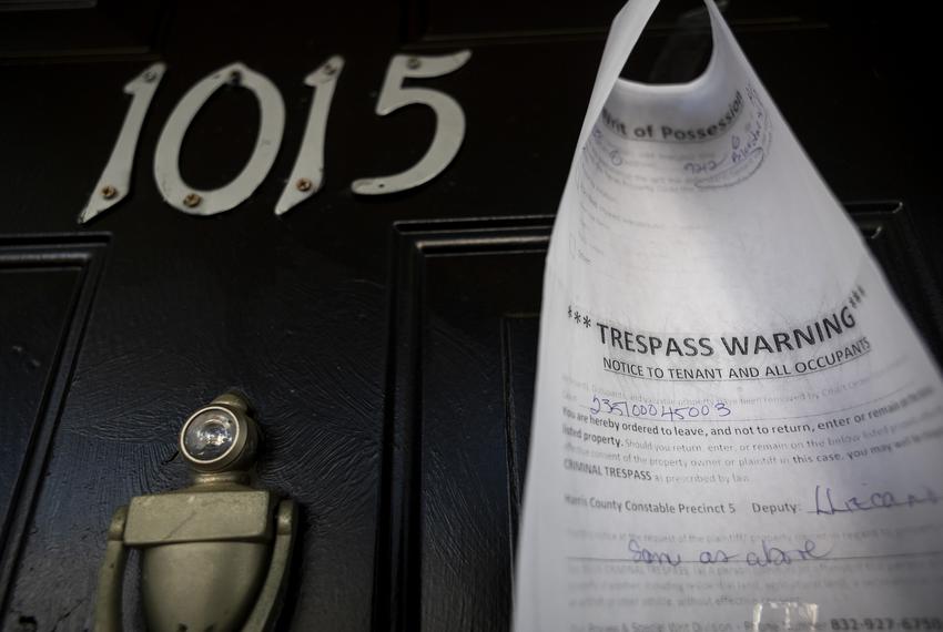A writ of possession is taped to the door of an apartment at the Life at Jackson Square apartments on Tuesday, April 11, 2023, in Houston, TX.