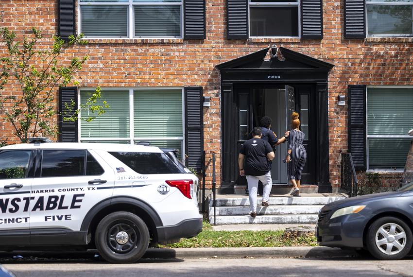 Property management and a constable enter an apartment complex at the Life at Jackson Square apartments on Tuesday, April 11, 2023, in Houston, TX.