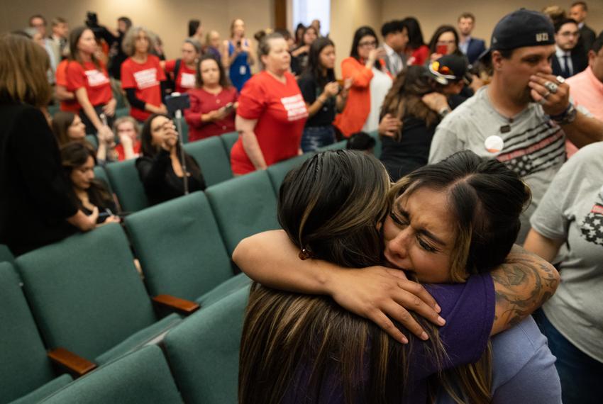 Family members of the victims of the Uvalde shooting cry and hug each other after the House Safety Committee voted in favor of HB 2744, to raise the age requirement to purchase semiautomatic rifles from 18 to 21, at the state Capitol in Austin on May 8, 2023.