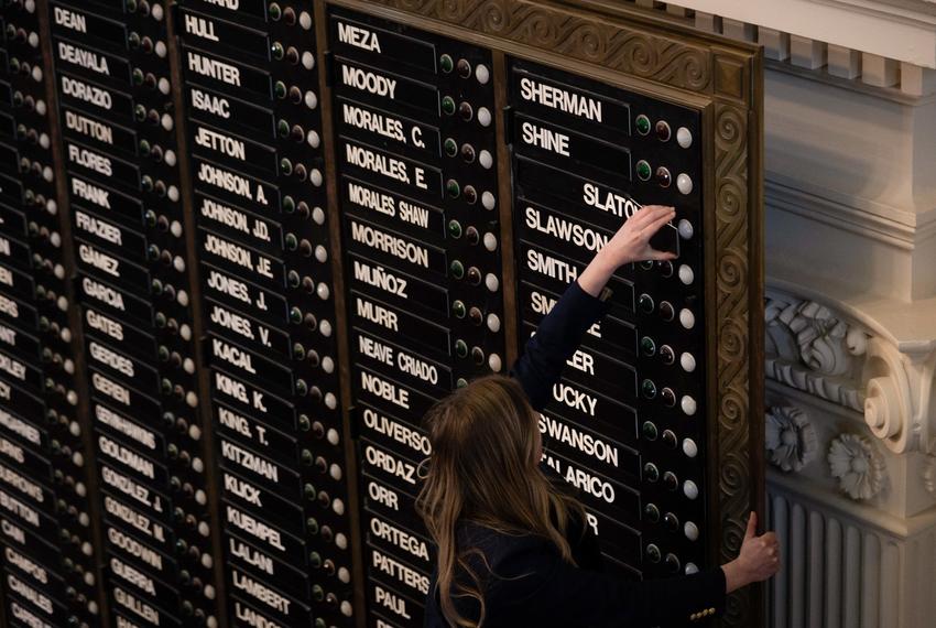 The Sergeant at Arms of the Texas House removes state Rep. Brian Slaton's name card from the House voting board after the House voted to expel Slaton at the state Capitol in Austin on May 9, 2023.