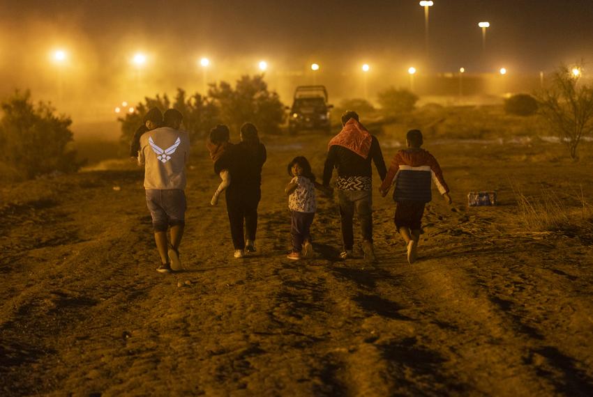 A migrant family from Peru walks towards the nearest port of entry after they crossed the Rio Grande back into Mexico after the family asked Texas National Guard Troops to be let inside a makeshift migrant camp to be processed about two hours after Title-42 ended at 9:59 p.m. local time, Friday, May 12, 2023, in Cd. Juarez, Mexico. The family was denied entry. Photo by Ivan Pierre Aguirre for The Texas Tribune