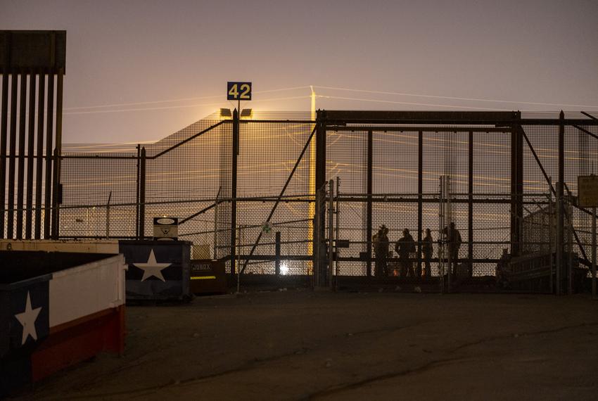 Members of the Texas National Guard and the Texas Department of Pubic Safety at the entrance to where hundreds of migrants wait to be processed by U.S. Customs and Border Protection agents inside a makeshift migrant camp about three hours after Title 42 ended at 9:59 p.m. local time, Friday, May 12, 2023, in El Paso.