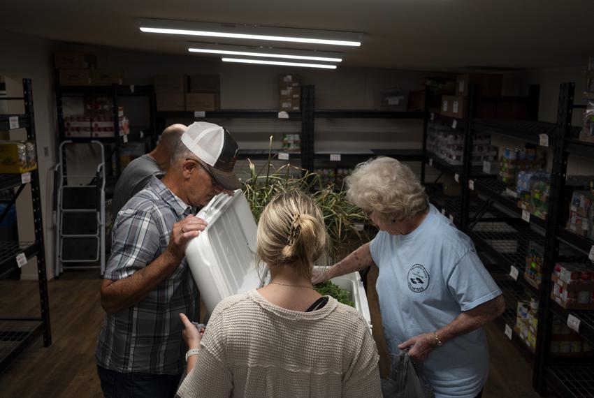 Volunteers prepare fresh vegetables donated by the Dewey Prairie Garden for distribution at the Lord’s Pantry of Leon County in Buffalo, Texas, on June 29, 2023.