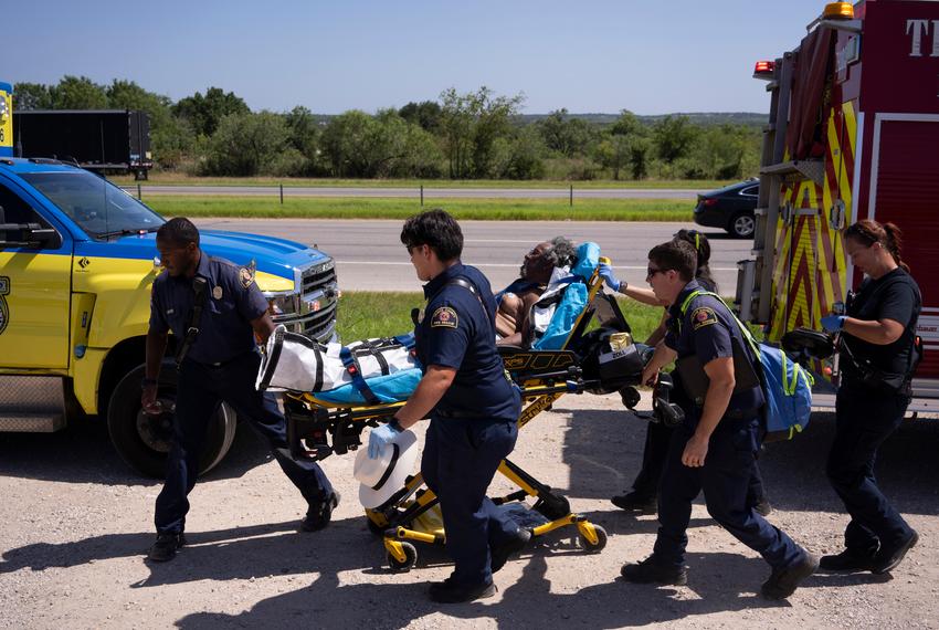 Austin-Travis County EMS first responders cart Robert Shipp, 75, of Bastrop, to an ambulance during a 102 degree summer day outside Austin Wrench A Part in Del Valle on July 7, 2023. According to the EMS crew and Shipp, he was seen passing out while searching for car parts under the hot sun, and hadn’t eaten any food or drank any water all day.