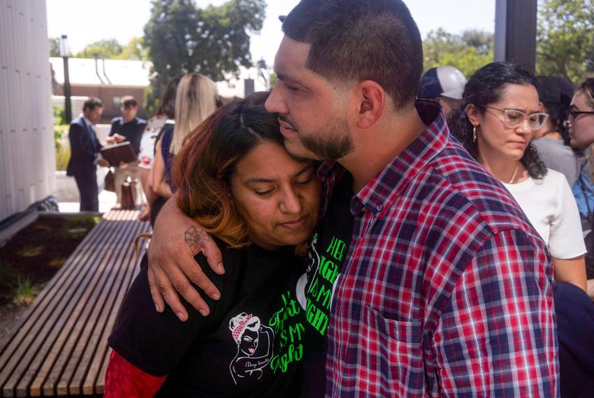 Samantha Casiano is comforted by her husband, Luis Fernando Villasana, following the first day of testimony for Zurawski v. State of Texas outside the Travis County Civil and Family Courts Facility in Austin on July 19, 2023.