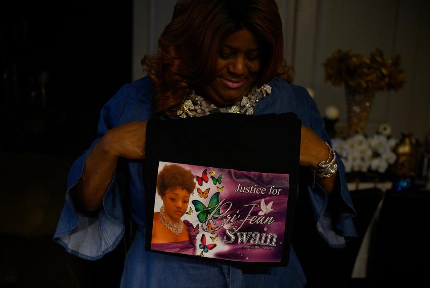 Sherri Johnson, the mother and biological grandmother of Bri'Jean Swain, a 17-year-old who was shot and killed in April, holds a shirt she made in honor of Bri’Jean at her home in Houston, Texas, U.S., on Monday, August 14, 2023. In 2022, young people, defined as those younger than 25, accounted for 26 percent of firearm deaths across the state.