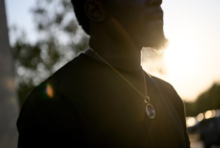 Marvin Porter, 22, whose family member Shane Hamilton was shot and killed in January poses for a portrait wearing a necklace featuring Shane in Baytown, Texas, U.S., on Saturday, August 19, 2023. In 2022, young people, defined as those younger than 25, accounted for 26 percent of firearm deaths across the state.