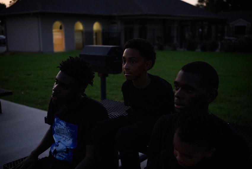 Markaven Washington, 15, Sebashton Bryant, 10, and Lionel Hamilton, 18, the brothers of 16-year-old Shane Hamilton, who was shot and killed in January, sit on a bench in Baytown, Texas, U.S., on Saturday, August 19, 2023. In 2022, young people, defined as those younger than 25, accounted for 26 percent of firearm deaths across the state.