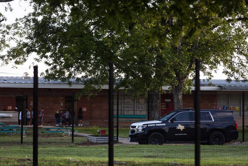 A DPS police vehicle sits outside of Dalton Elementary School as students wait outside their classroom on the first day of school in Uvalde on Sept. 6, 2022.