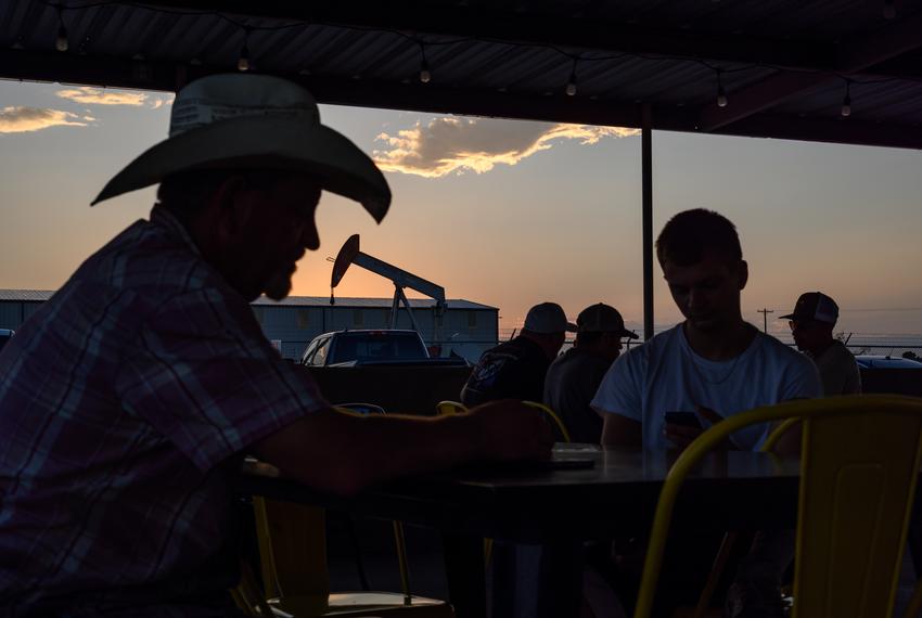 Ruben Pando, left, and his son Armando Pando, second from right, sit down for a meal at El Taco Loco Brirrieria as the sun begins to set Thursday, Sept. 14, 2023 in West Odessa.