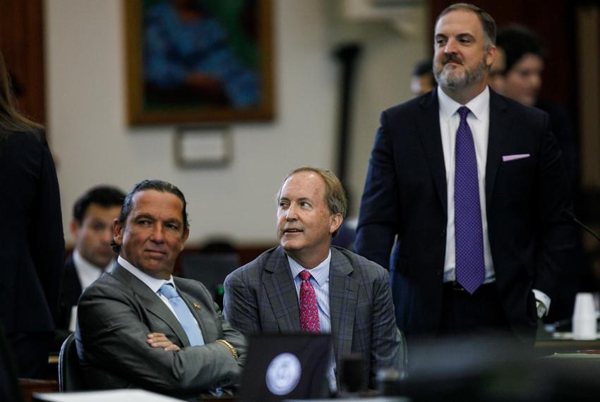 Texas Attorney General Ken Paxton, center, sits between defense attorneys Tony Buzbee, left, and Mitch Little, right, before starting the ninth day of his impeachment trial in the Senate Chamber at the Texas Capitol on Friday, Sept. 15, 2023, in Austin, Texas.