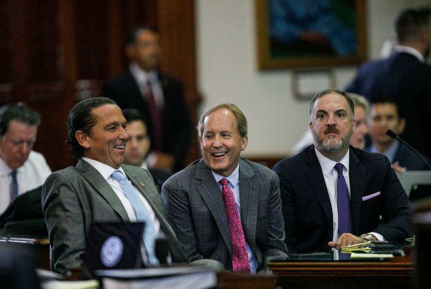Texas Attorney General Ken Paxton, center, sits between defense attorneys Tony Buzbee, left, and Mitch Little, right, before starting the ninth day of his impeachment trial in the Senate chamber at the Texas Capitol on Sept. 15, 2023.