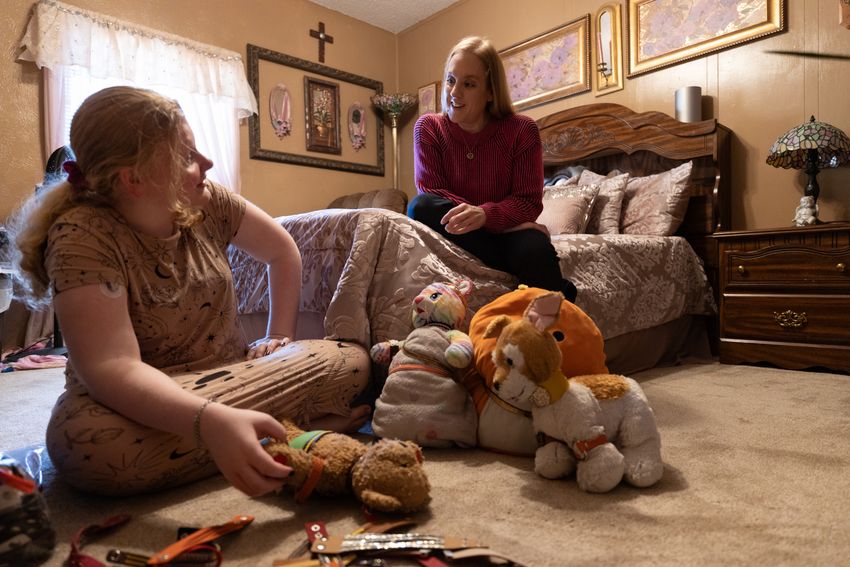 Ashlyn Mosley, 13,  "bedazzles" her stuffed animals with her mother, Jennifer Antwine, in Fort Worth, Texas on Oct. 20, 2023.