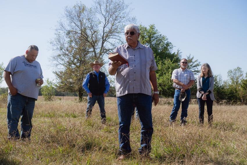Pastor Paul Fixico, 70, member of Tokvbvche Methodist Church and affiliated with the Muscogee Creek Tribe of Oklahoma, (center) prays during a blessing ceremony for three herds of bison gifted to Theda Pogue, affiliated with the Muscogee Creek Nation of Oklahoma, and her family on Saturday, November 4, 2023 at GP Ranch in Sulphur Springs, Texas.