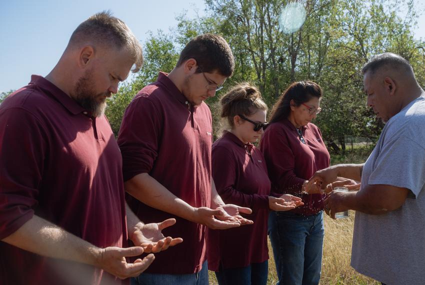 From left, Chris Pogue, 43, Rowdy Pogue, 20, affiliated with the Seminole Nation of Oklahoma, Skylar Gainer, 26, affiliated with the Seminole Nation of Oklahoma, and Theda Pogue, 45, affiliated with the Muscogee Creek Nation of Oklahoma, receive a blessing from Reverend Eric Thlocco, member of Tokvbvche Methodist Church and affiliated with the Seminole Nation of Oklahoma, (right) during a ceremony for three herds of bison gifted to the family on Saturday, November 4, 2023 at GP Ranch in Sulphur Springs, Texas.