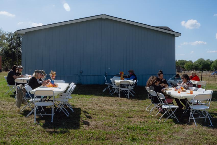 People, including tribe members, eat a meal following a blessing ceremony for the three herds of bison gifted to Theda Pogue, affiliated with the Muscogee Creek Nation of Oklahoma, and her family on Saturday, November 4, 2023 at GP Ranch in Sulphur Springs, Texas. The meal included three cuts of bison meat prepared by Curtis Fulgham, 43, chef at Social Lounge.