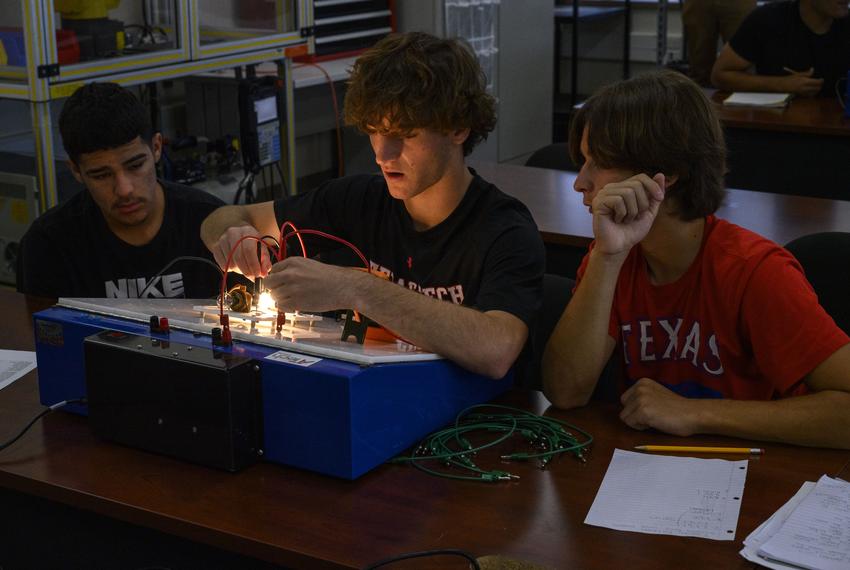 From left, Legacy High School juniors Giovanni Parra, 17, Luke Frysak, 17, and Isaiah Estrada, 16, take part in a lesson on electrical circuits during their Oil and Gas Production II class Monday, Nov. 6, 2023 in Midland.