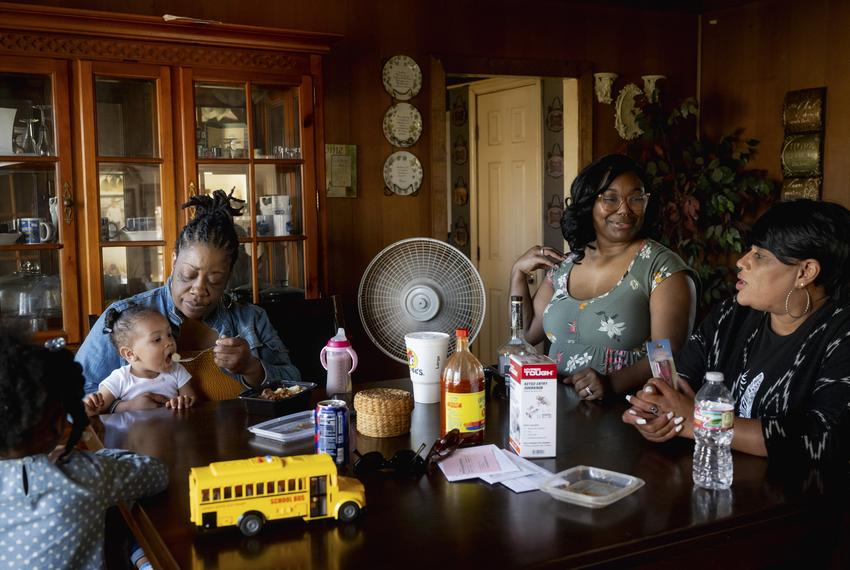 Nikki Murray feeds her granddaughter, Auriella Murray, 1, while sitting with her family members at her home on Sunday, December 3, 2023 in Vernon. Murray, who works as a cashier at McDonald’s, attended Vernon College in the early 2000s but withdrew to raise her two kids while in an abusive relationship. College is still a dream for her, but she is currently settled in her job and continues to focus on caring for her family.