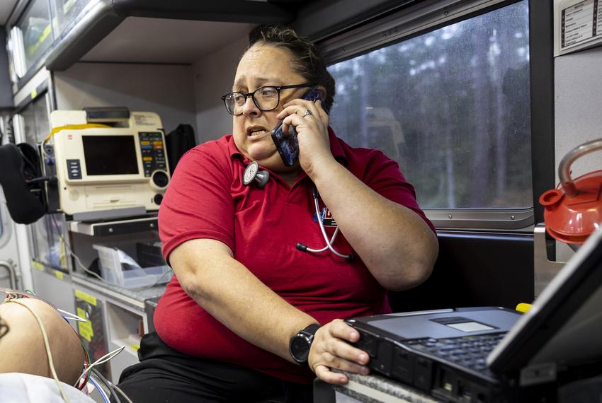 EMT Ronnie Robison calls the Woodland Heights Medical Center to tell them to prepare for an opioid overdose patient  at the Lufkin facility Friday, Dec. 16, 2022. Robison has to call on a certain street of highway before a “dead zone” of no cell service or they will not be able to warn the trauma team to prepare for their patients.