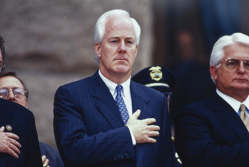 John Cornyn historical photos by Bob Daemmrich.    The year is in the file name.   

John Cornyn sitting next to Rep. Kim Brimer.  On the left is House Speaker Pete Laney.   This was probably a Peace Officer's Memorial on the south steps of the Texas Capitol. 