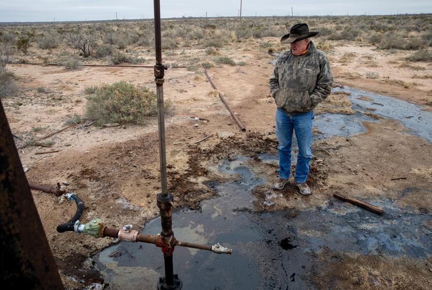 Rancher Schyler Wight surveys the puddles of crude oil that have been leaking from an abandoned well on his property.                                            (Rancher Schyler Wight surveys the puddles of crude oil that have been leaking from an aba