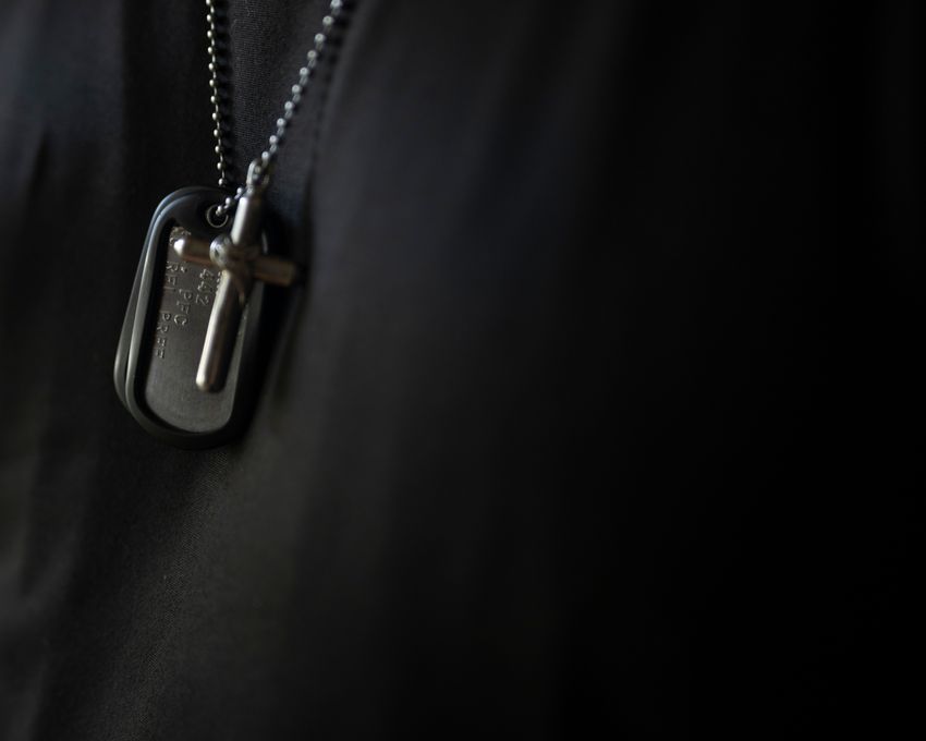 Logan Castello’s dog tags and a cross with some of his ashes are worn by his father Kenny Castello, 50, Thursday, May 4, 2023 in Barnesville, Ohio. Castello said the sergeant who attended his son’s funeral took them off of Castello’s body and gave them to him before the cremation.