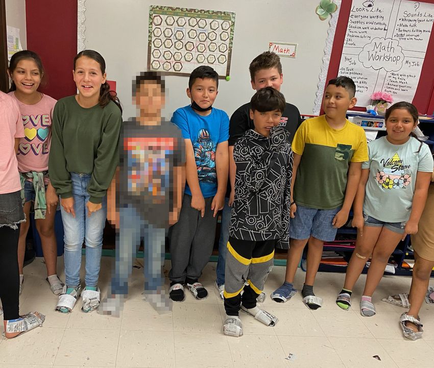 Elsa Avila’s students pose for a picture in their newspaper shoes moments before the shooter entered their school. Children’s faces are shown with parental consent.