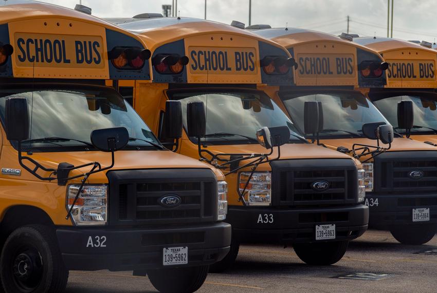 School busses are parked at the Austin Independent School District bus center on July 10, 2020 in Sunset Valley.