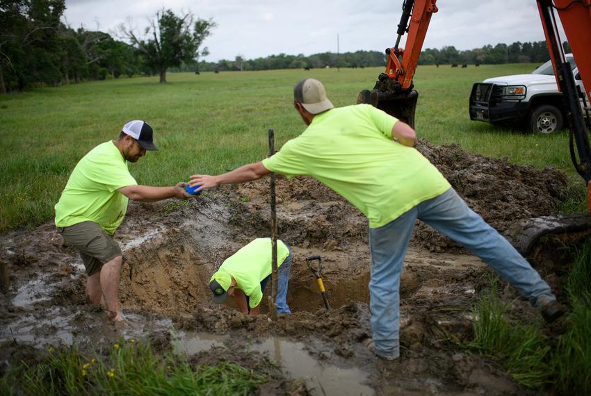 Consolidated Water Supply Corporation employees patch a broken pipe on April 19, 2023 in Crockett.