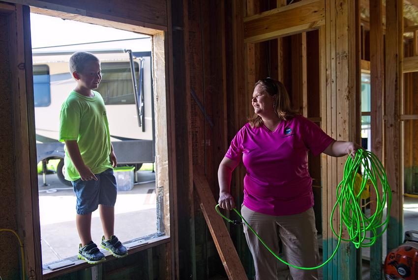Danielle Hale and her son, Conner, 8 help friends rebuild their home damaged by Hurricane Harvey, on August 11, 2018.