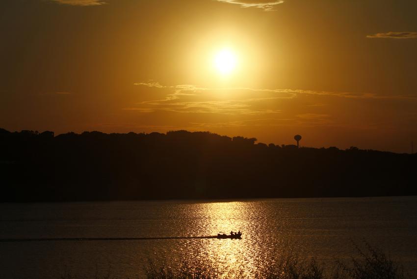 A boat traveled along Lake Travis during a drought in the summer of 2011. Drier than normal weather in Texas with no precipitation for several months had caused lakes and rivers to run dry.