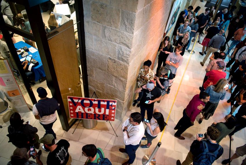 Voter wait in line at Austin City Hall to cast their ballots on Nov. 5, 2019. 