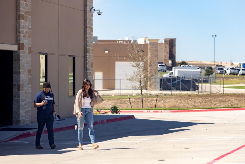 Conservative social media personality Ella Maulding (right) and Fort Worth-based podcaster Kaden Lopez exit the offices of Pale Horse Strategies in Fort Worth, Texas on Oct. 6, 2023.