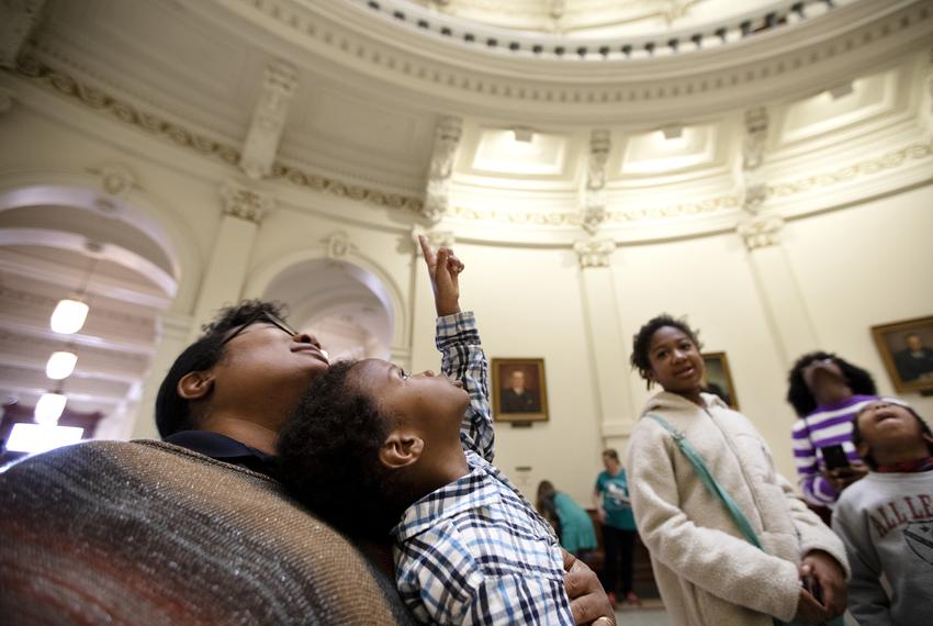 Chyrece Campbell holds Pierce Campbell as he looks up at the rotunda at the state capitol. Chyrece and her children, also pictured, Madison, Gregory and Kennedy, are visiting the capitol on the first day of the 86th legislative session. Miguel Gutierrez Jr.