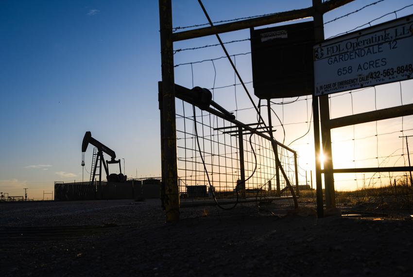 The sun begins to set behind a pumpjack site in Gardendale on Sunday, Feb. 6, 2022.