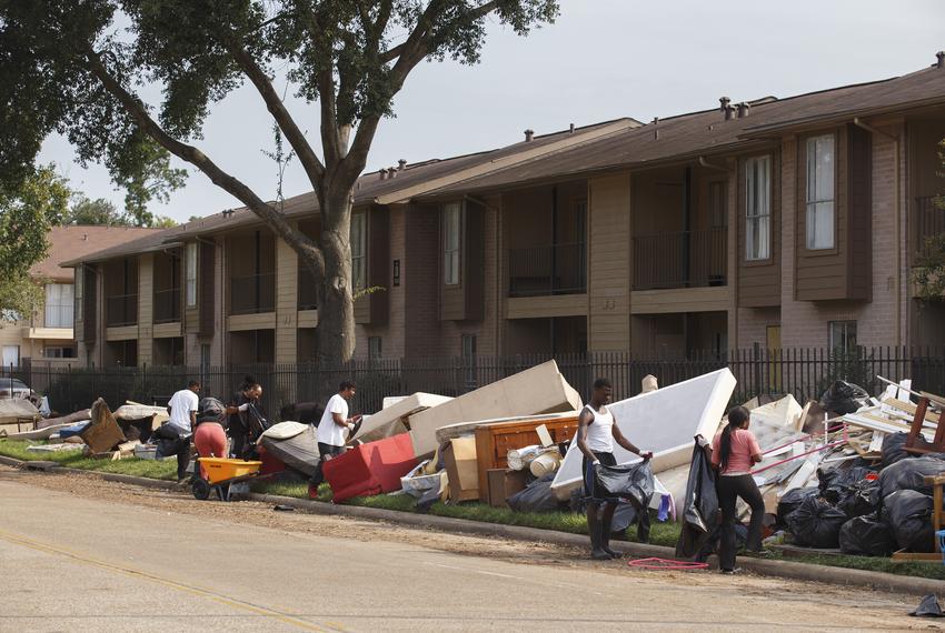 Workers sort through piles of flooded belongings at an apartment complex near Greens Bayou in the Greenspoint area of  Houston on Wednesday, Sept. 6, 2017, days after Tropical Storm Harvey dissipated.