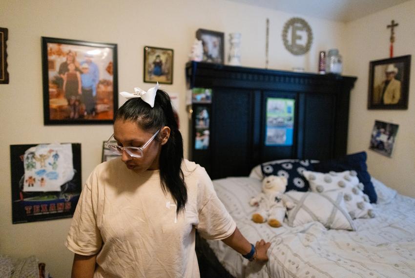 Surrounded by walls covered with frame photos of her husband, Eliberto Ortega who died while battling COVID-19 in July 2021, closes her eyes before exiting the room to take care of her two children, Wednesday, Sept. 27, 2023, in Houston. (Marie D. De Jesús / Houston Landing)
