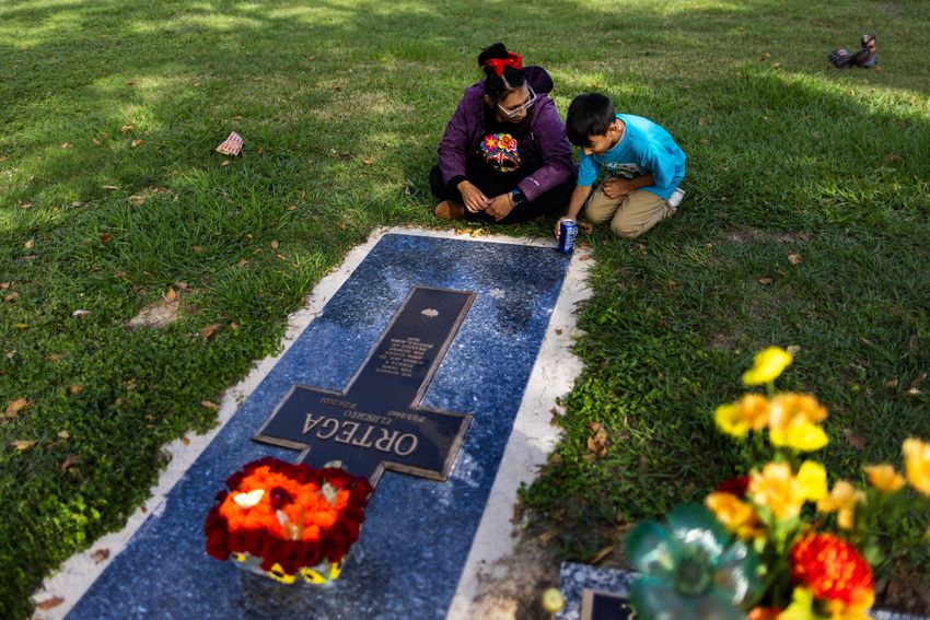 Laura Ortega visits her husband Eliberto Ortega’s grave on Día de los Muertos along with their seven-year-old son to pay their respects, Thursday, Nov. 2, 2023, in Houston. Eliberto died of cardiac arrest while sick with the coronavirus in July 2021. (Marie D. De Jesús / Houston Landing)