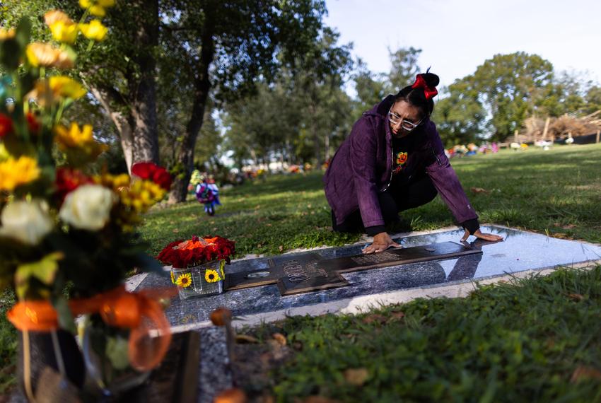 Laura Ortega visits her husband Eliberto Ortega’s grave on Día de los Muertos along with their children to pay their respects, Thursday, Nov. 2, 2023, in Houston. Eliberto died of cardiac arrest while sick with the coronavirus in July 2021. (Marie D. De Jesús / Houston Landing)