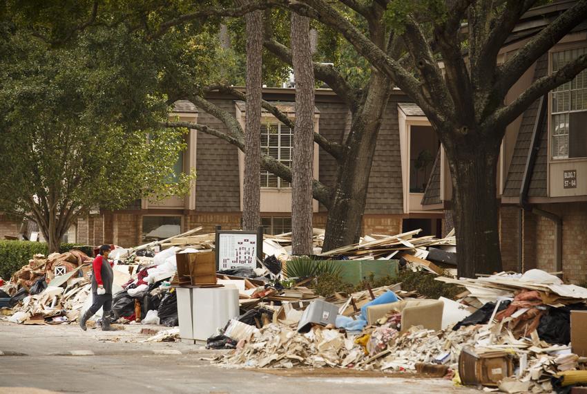 Debris from Hurricane Harvey is piled high at the Pines Condominiums near the Buffalo Bayou in the Memorial area of Houston on Sept. 13, 2017.