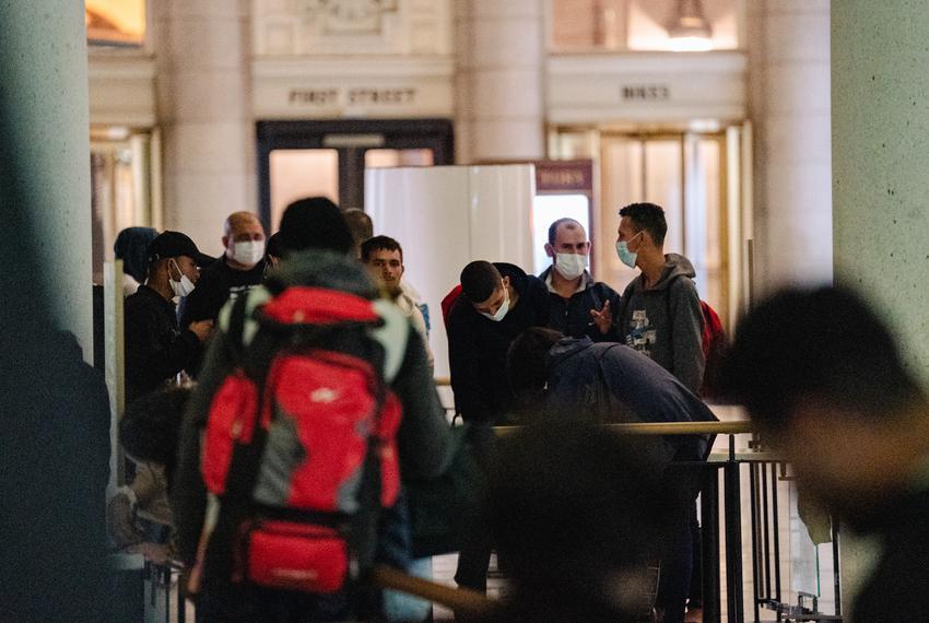 Two buses transporting migrants from Texas arrive at Union Station on April 21, 2022. Gov. Greg Abbott’s new plan in response to the end of Title 42, a pandemic-era emergency health order which allowed immigration authorities at the border to deny entry.