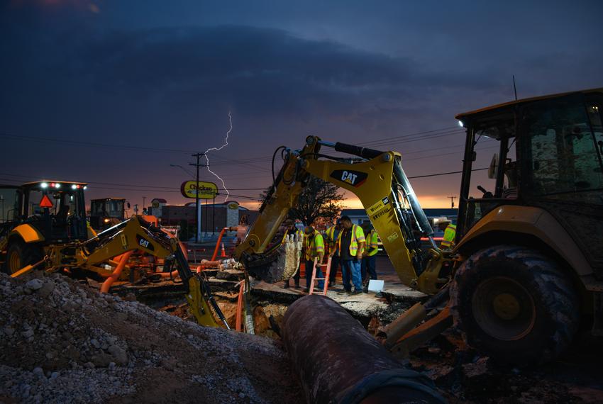 Lightning from a passing storm strikes in the vicinity as City of Odessa Water Distribution employees work through the night to repair a broken water main Tuesday, June 14, 2022 in Odessa. According to Mayor of Odessa Javier Joven, repairs were completed around 3:45 a.m. Wednesday.