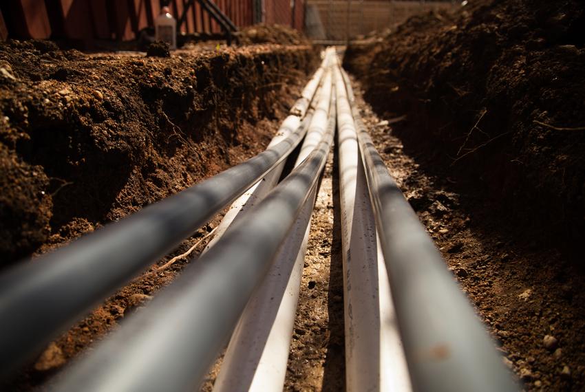 Pipes lie in a trench inside the Regency Apartment complex in Austin on Feb. 24, 2021.