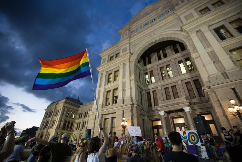 Members of Austin's LGBT community gather on the steps of the capitol to celebrate the anniversary of the 1969 Stonewall riots on June 28, 2017.