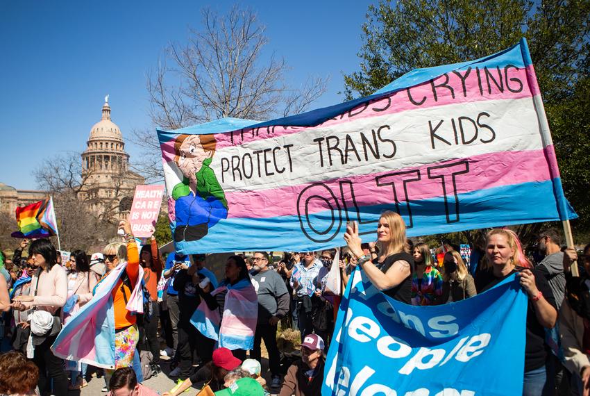 People gather for the Trans Kids Call for HELP! rally in front of the Governor's Mansion in Austin on March 13, 2022.